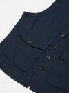 Close-up of the Navy Twill Field Waistcoat on a white background. The waistcoat is navy blue with brown buttons and multiple pockets.