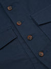 Close-up of the Navy Twill Field Waistcoat. Shows the navy twill fabric, brown buttons, and pocket details. The image is tightly cropped.
