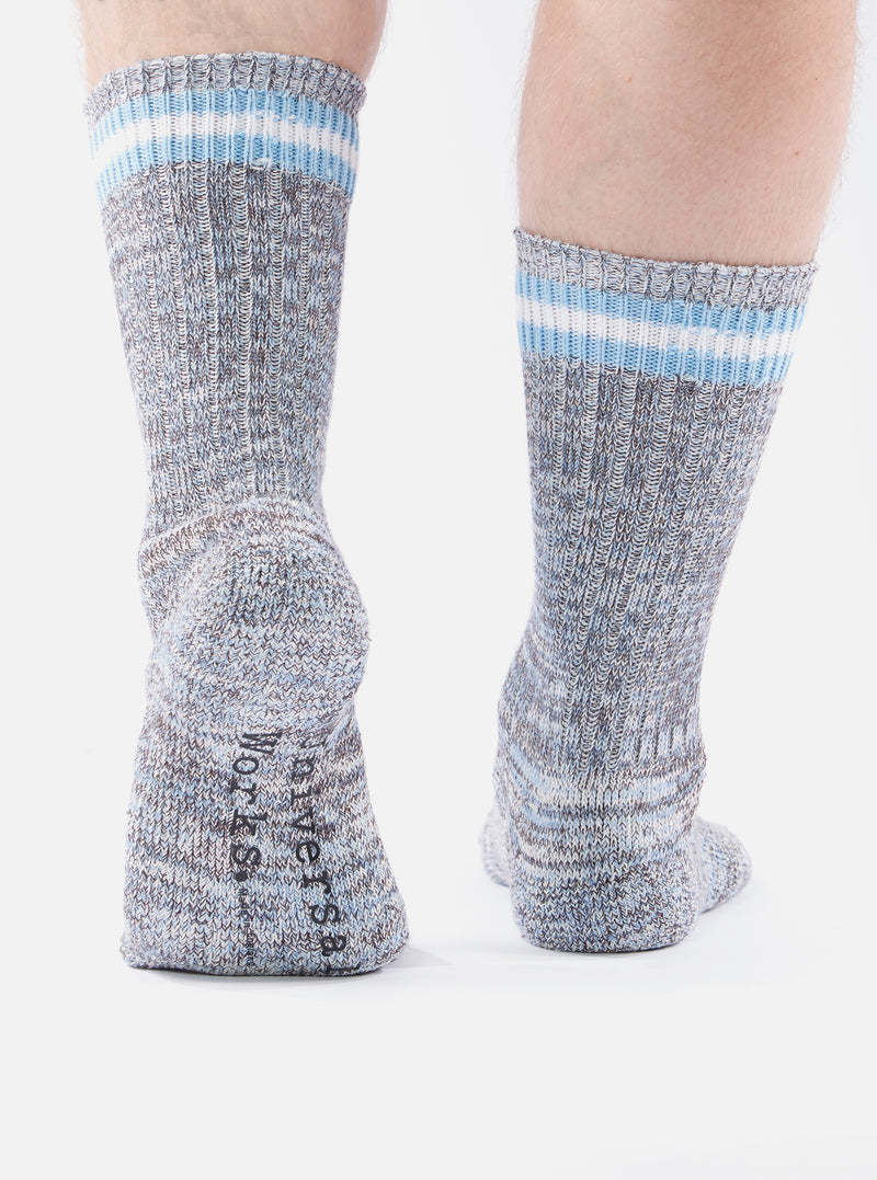 Close-up of the back of two legs wearing Cornish Blue Cotton Everyday Stripe Sock on a white background. The socks are striped with blue and white at the top.