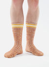 Close-up of a person wearing Yellow Cotton Everyday Stripe Sock on a white background. The socks are striped with yellow and white.