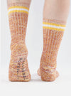 Close-up of a person wearing Yellow Cotton Everyday Stripe Sock on a white background. The socks have yellow and white stripes at the top and a textured knit pattern.