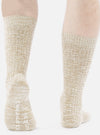 Close-up of a model wearing Dark Sand Slub Knit Slub Socks. The socks are a textured knit in a neutral sand color, set against a plain white background.