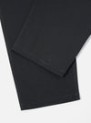 Close-up of the Black Twill Hi Water Trouser showing the fabric detail and hem. The trousers are on a white surface.