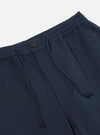 Close-up of the Navy Twill Hi Water Trouser on a white background. Shows the elastic waistband, drawstring, button, and twill fabric detail.