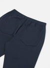 Close-up of the back of navy twill hi water trouser on a white background. Shows the elastic waistband and back pockets.