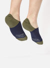 Close-up of feet wearing Navy/Olive Cotton Mix Knit No Show Sock. The socks are knit with a navy and olive color block design. Studio shot on white.