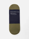 Close-up of a Navy/Olive Cotton Mix Knit No Show Sock on a white surface. The sock features olive green and navy stripes with 'Universal Works' in white lettering.